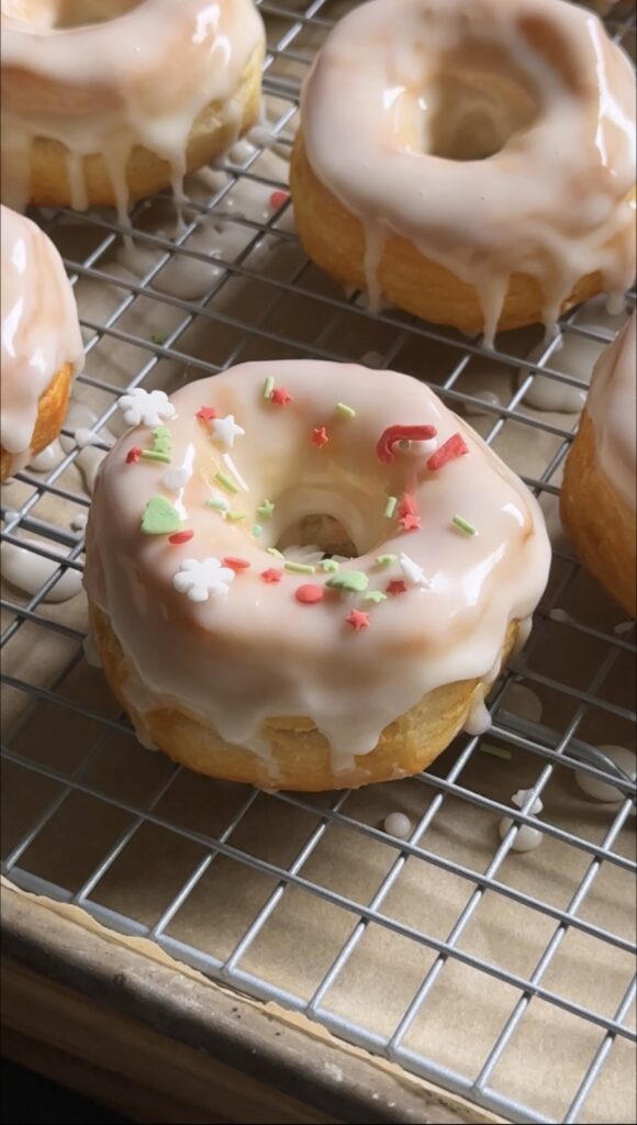 glazed air fryer donuts sitting on wire rack.