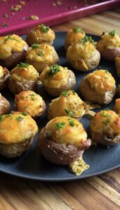 mini twice-baked potatoes on a dark plate