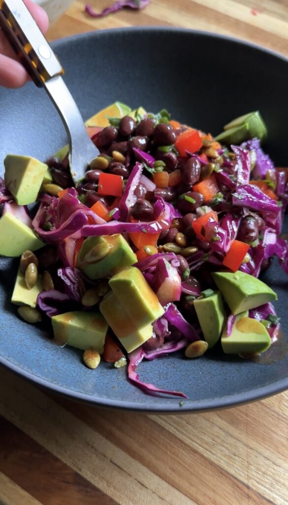 fork digging into a bowl of veggie-packed sweet potato boats