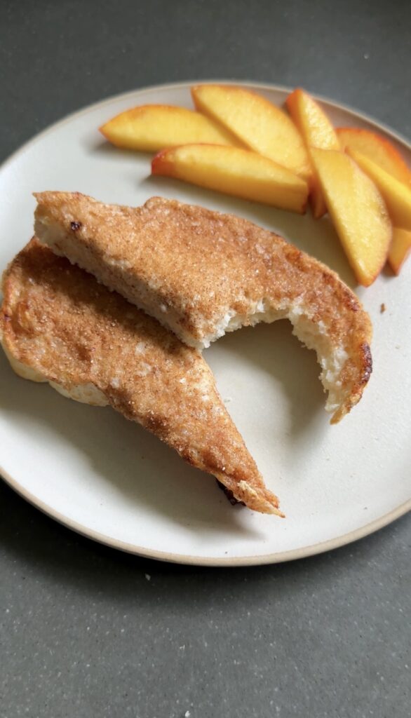 cottage cheese cinnamon toast sliced on a plate with peach slices