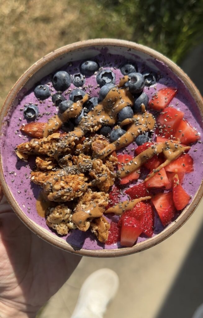 hand holding cottage cheese breakfast bowls outside