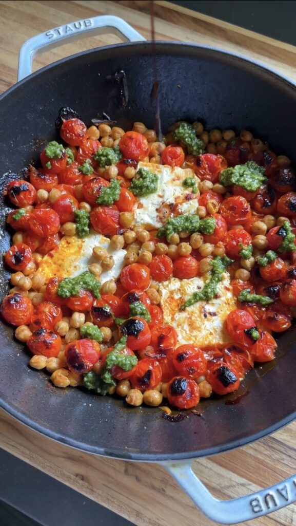 roasted feta caprese skillet on a wooden cutting board