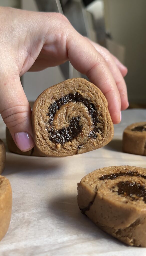 hand holding no-bake cinnamon rolls