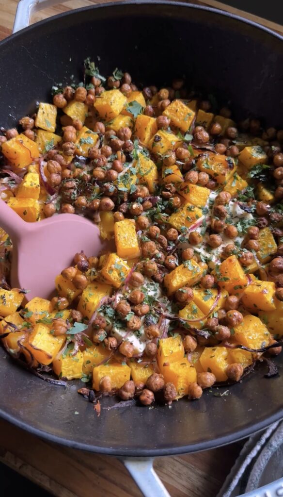 spatula entering a roasted squash and feta skillet