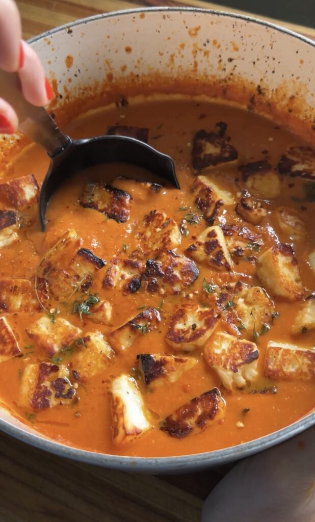 ladle going into roasted tomato soup