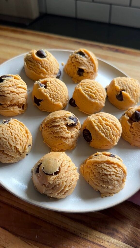 a plate of protein cookie dough balls with chocolate chips