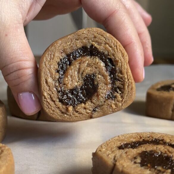 hand holding no-bake cinnamon rolls