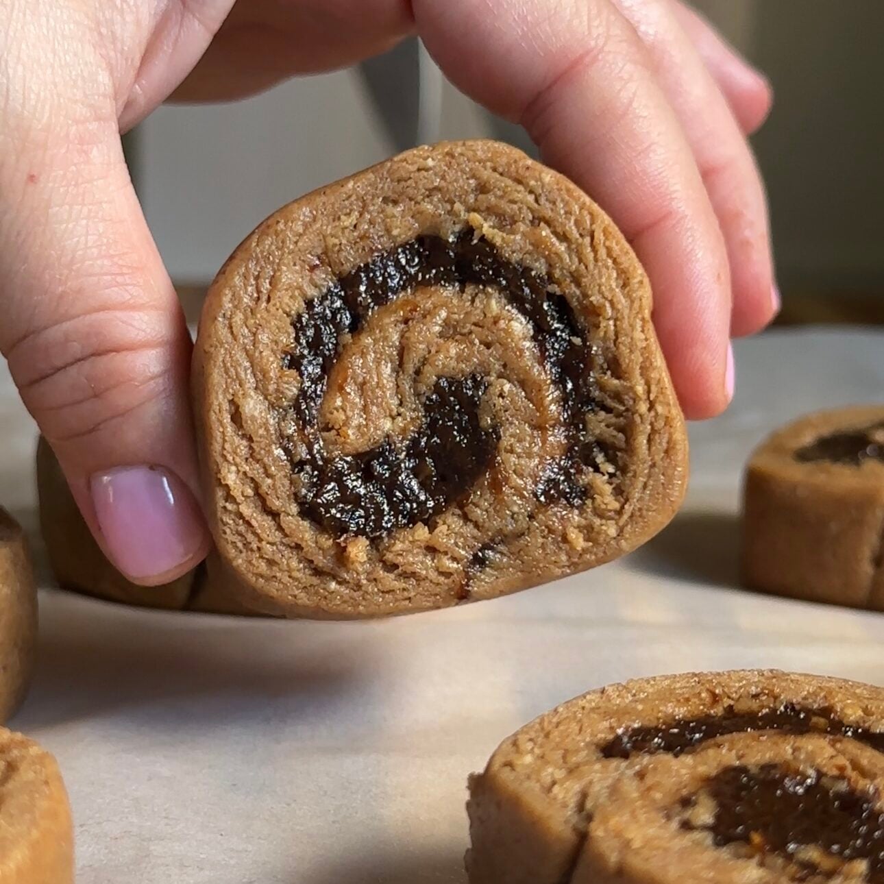 hand holding no-bake cinnamon rolls