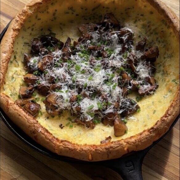 savory cottage cheese dutch baby on cutting board