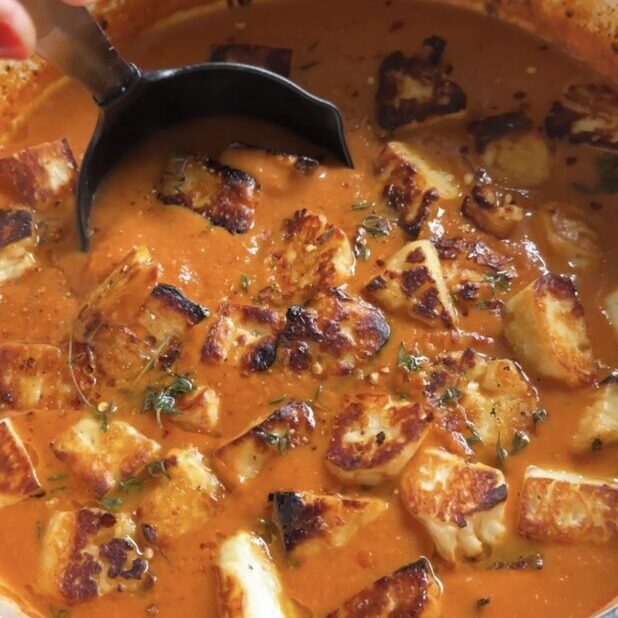 ladle going into roasted tomato soup