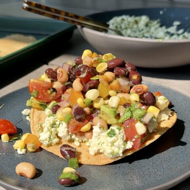 smashed feta tostadas with corn and bean salsa on outdoor table