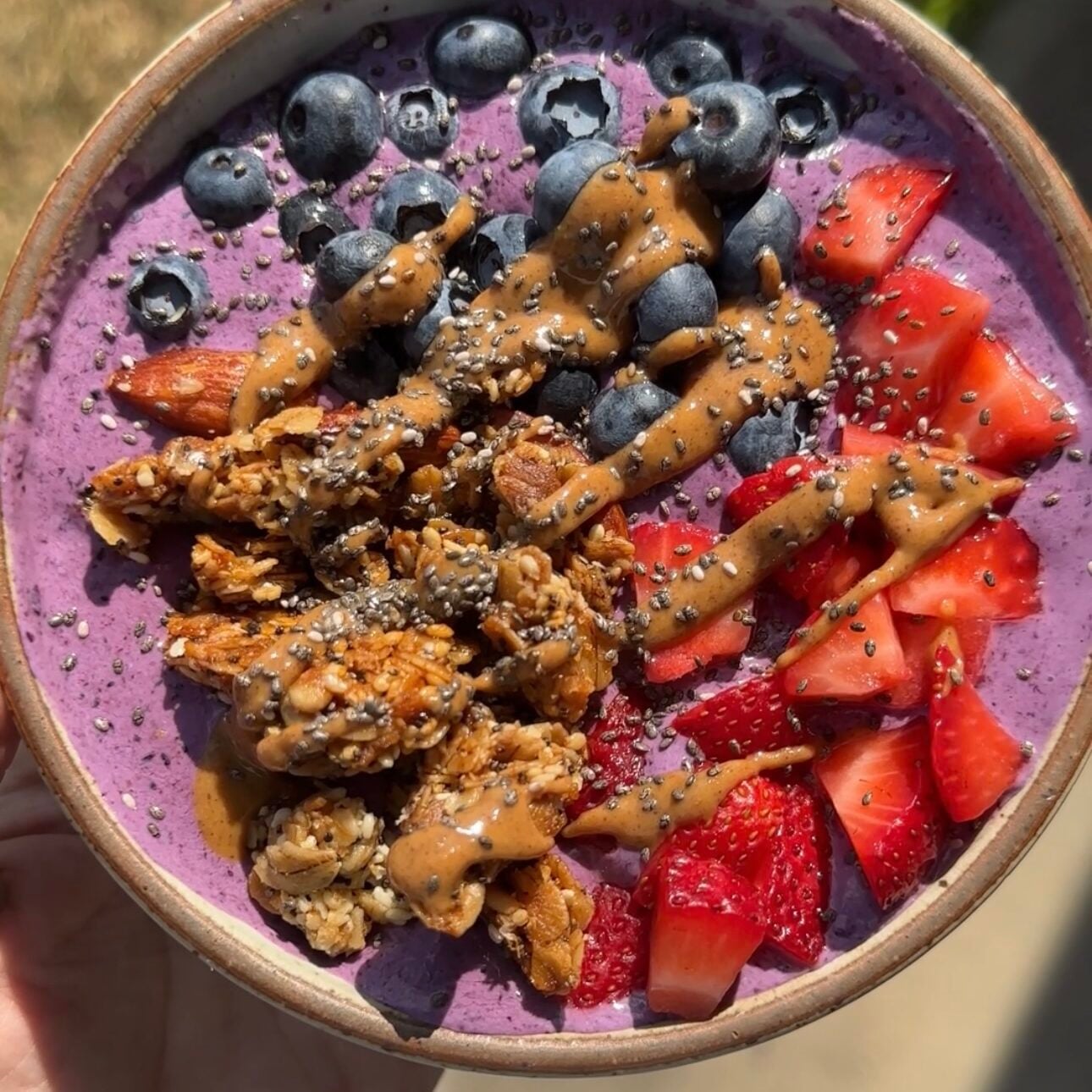 hand holding cottage cheese breakfast bowls outside