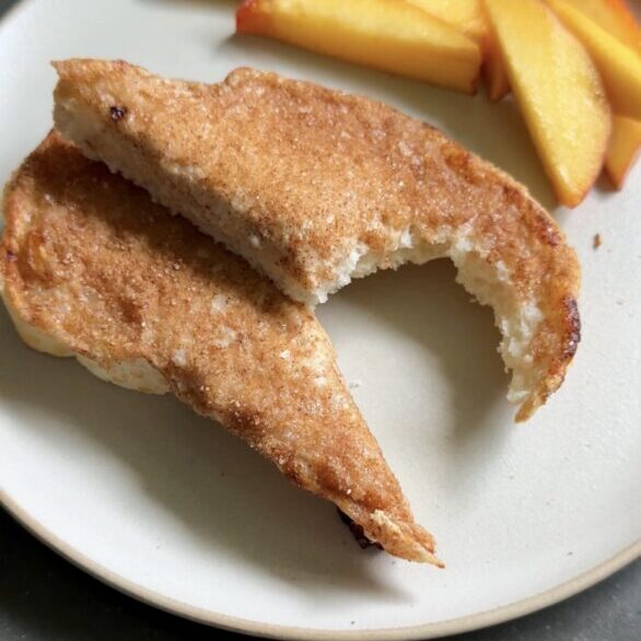 cottage cheese cinnamon toast sliced on a plate with peach slices