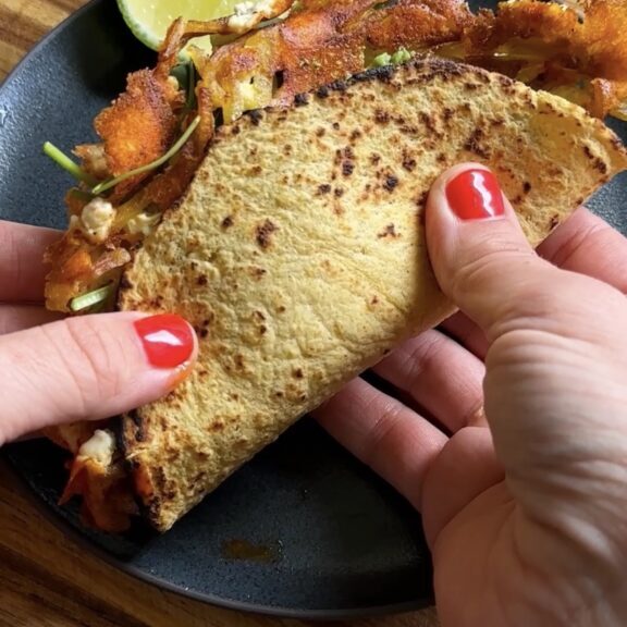 hand holding crispy feta tacos