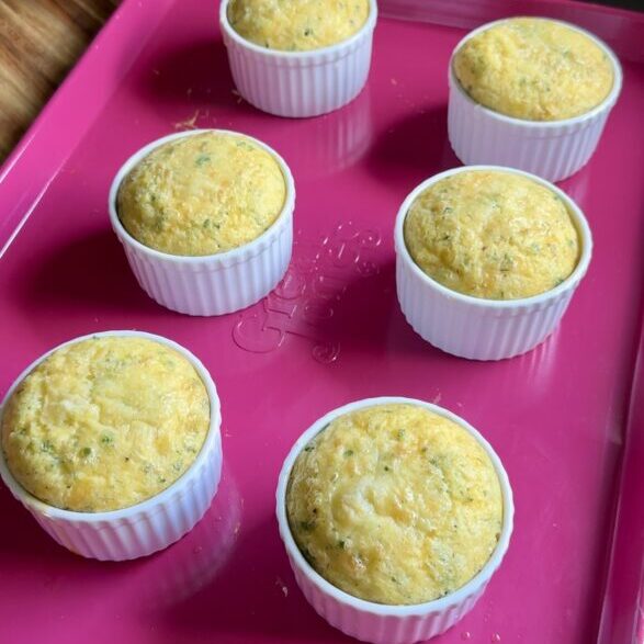 mini egg bakes sitting on a pink baking sheet