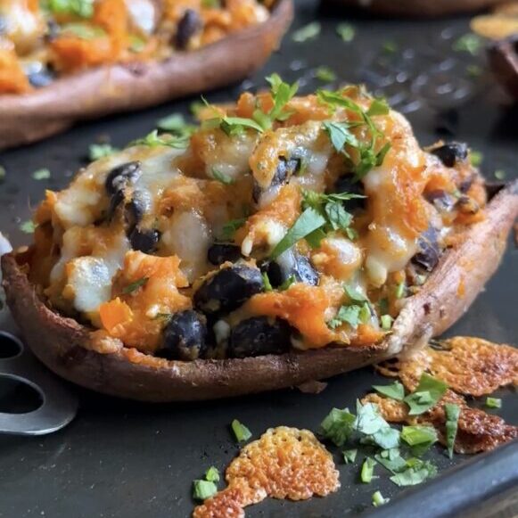 high-protein sweet potato boats on a black baking sheet