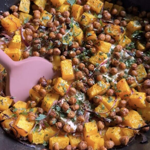spatula entering a roasted squash and feta skillet