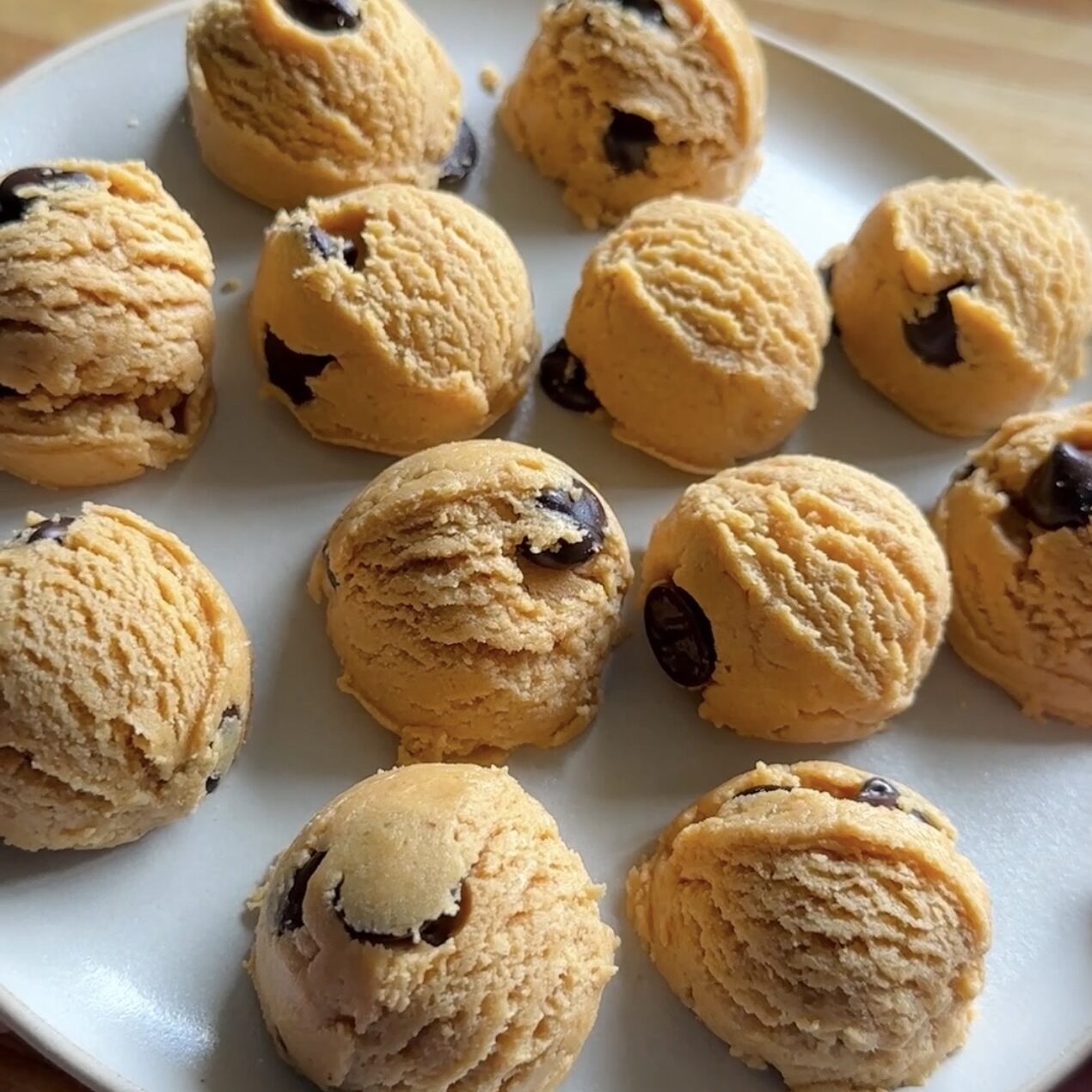 a plate of protein cookie dough balls with chocolate chips