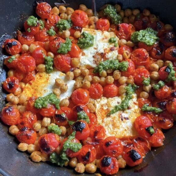 roasted feta caprese skillet on a wooden cutting board