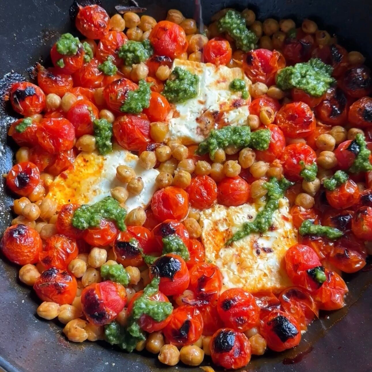 roasted feta caprese skillet on a wooden cutting board