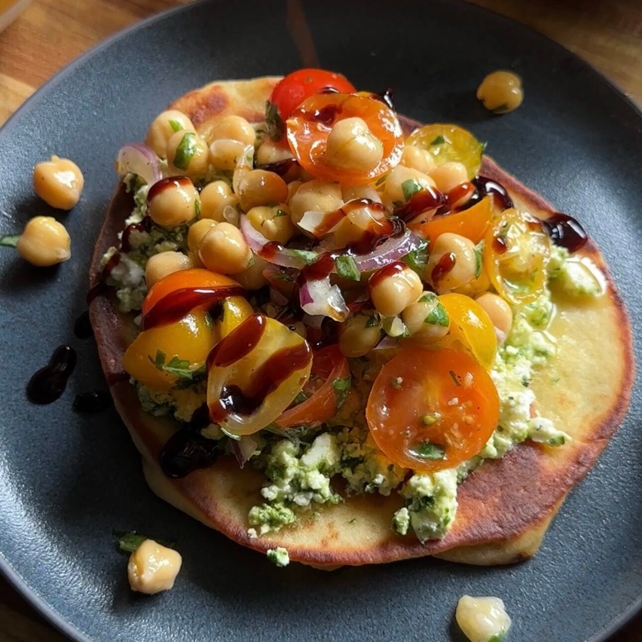 smashed feta caprese flatbread on a plate