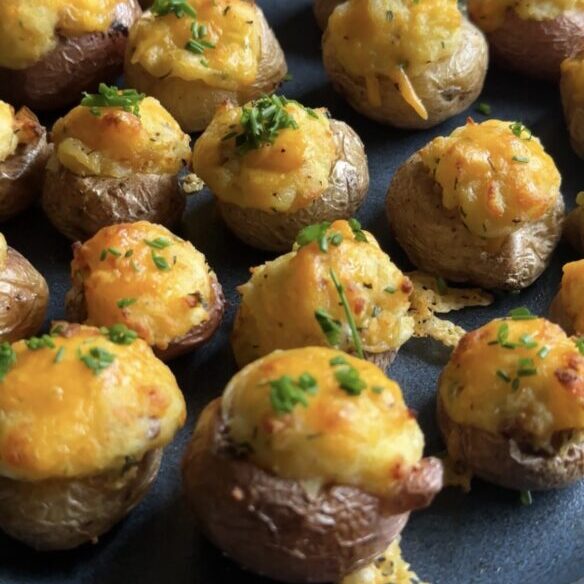 mini twice-baked potatoes on a dark plate