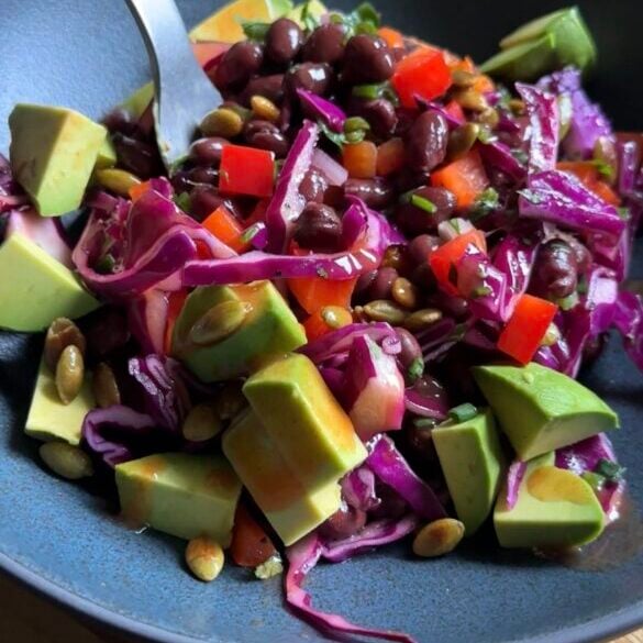 fork digging into a bowl of veggie-packed sweet potato boats